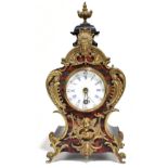 A late 19th century French ebonised simulated Boulle work and brass mounted mantel clock with