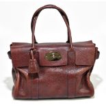 MULBERRY; a Bayswater oxblood leather handbag with gold tone embossed turn lock front fastening,