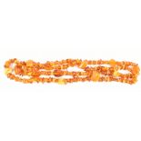 A Baltic amber necklace formed of three graduated drops each set with rough cut pieces, approx 96.