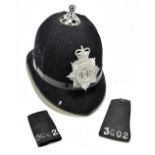 A police helmet bearing plaque inscribed ‘Devon & Cornwall Constabulary’, length 32cm, with two