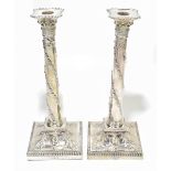 A pair of late 19th century Adam style silver plated candlesticks, with detachable nozzles and