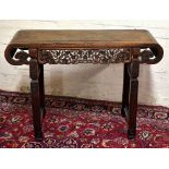 An early to mid 20th century Chinese carved rosewood altar table, with carved floral decoration to