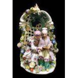 MEISSEN; a 19th century figure group of a Chinese couple in an arbor after the original by Reinicke,