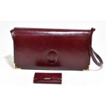 CARTIER; a Must de Cartier burgundy Bordeaux leather vintage shoulder bag with top flap fastening