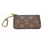 LOUIS VUITTON; a brown leather Monogram Pochette Cles wallet/coin purse with gold tone stamped