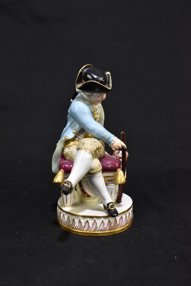 MEISSEN; an early 20th century figure of a seated huntsman with hound by his feet, painted marks and - Image 2 of 8