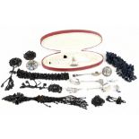 A small selection of costume jewellery including simulated pearls, jet and various white metal