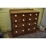 A Victorian pine chest of two rows of four graduated long drawers, with ceramic handles, on plinth