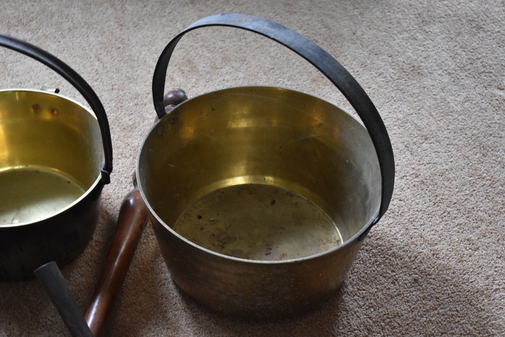 Four brass and cast iron preserving pans, the largest diameter 32.5cm, also a smaller brass saucepan - Image 4 of 4