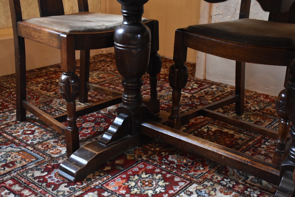 A 1930s oak draw-leaf dining table, with baluster legs on standard end supports, height 76cm, - Bild 3 aus 4