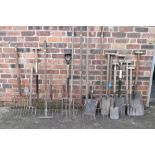 A collection of twenty assorted spades, mucking out forks, garden forks, rakes, etc. PROVENANCE: The