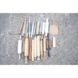 A collection of sixteen vintage treen, glass, marble, and plastic rolling pins, also an ash