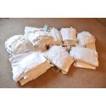 A collection of Edwardian and later white work and lace, including tablecloths, cushions, napkins,