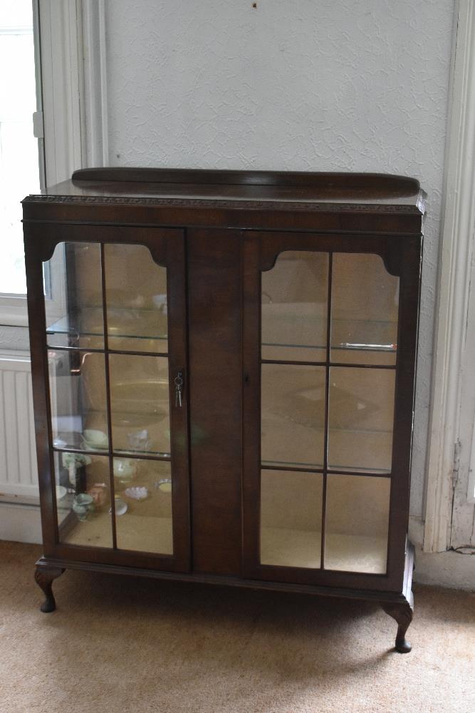 A 1930s walnut two door display cabinet, on cabriole legs, height 108cm, width 100cm, depth 33cm.
