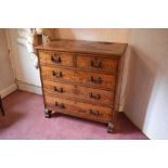 A late Victorian pitch pine chest of two short and three long drawers, on carved block feet,