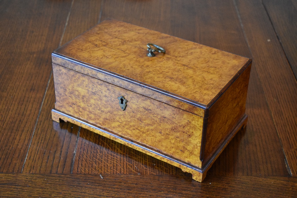 A Victorian amboyna box, with internal tray, on bracket feet, height 14cm, width 13cm, depth 18cm.