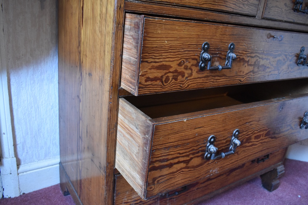 A late Victorian pitch pine chest of two short and three long drawers, on carved block feet, - Image 8 of 8