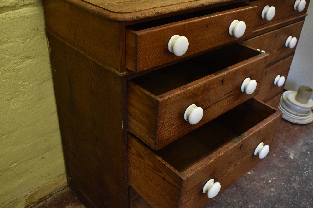 A Victorian pine chest of two rows of four graduated long drawers, with ceramic handles, on plinth - Image 6 of 7