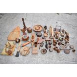 A large selection of mostly 20th century treen items including a candlestick, chamberstick, model