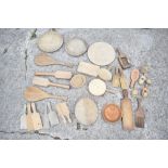 A selection of treen butter production items, including ten butter pats, seven butter prints, a