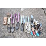 A selection of plastic and metal shoe stretchers, also a pair of leather mounted carved wood