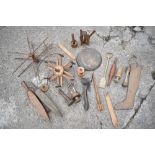 A collection of 19th century and later treen tools and implements, including two wool winders, a