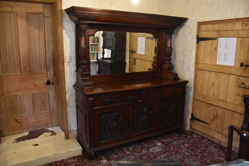 A Victorian carved walnut mirror back sideboard, with dentil cornice above two fluted and carved
