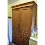 A Victorian pine housekeeper's cupboard, with two panelled cupboard doors enclosing shelves above