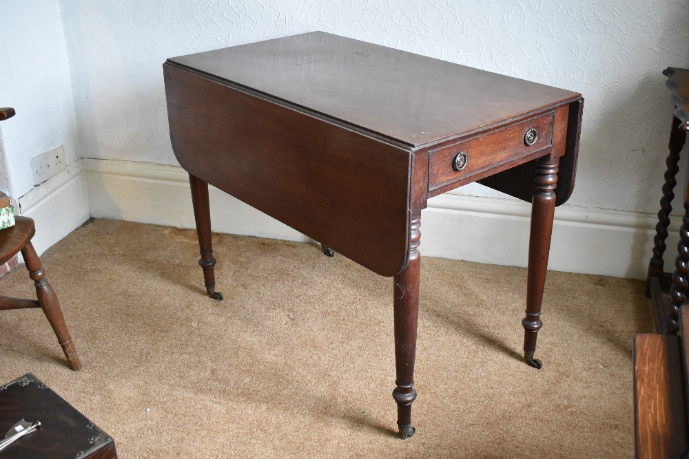 An early 19th century mahogany Pembroke table, with drawer and raised on turned and tapered legs,