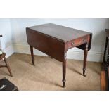 An early 19th century mahogany Pembroke table, with drawer and raised on turned and tapered legs,