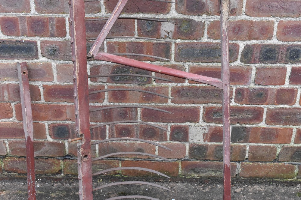 A vintage red painted wood and iron hay rake, two scythes, two potato forks, a fork and a fork head. - Image 8 of 8