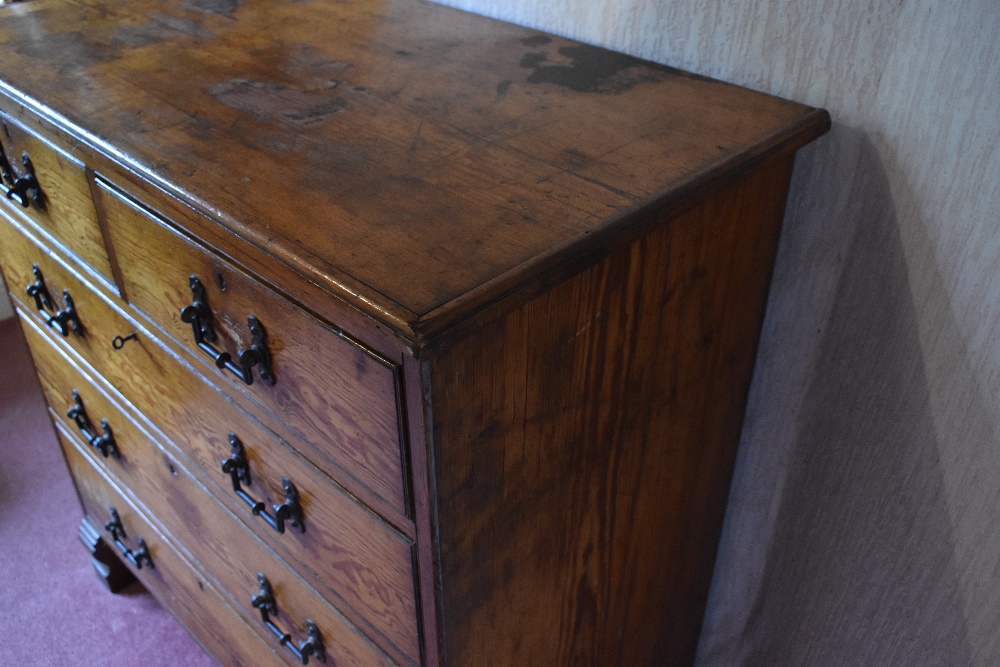 A late Victorian pitch pine chest of two short and three long drawers, on carved block feet, - Image 2 of 8