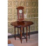 An oak gate leg table, height 72cm, with a Gustav Becker wall clock (2) PROVENANCE: The Raymond Rush