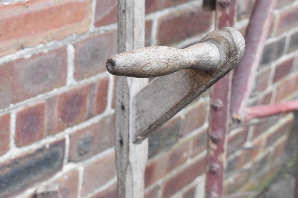 A vintage red painted wood and iron hay rake, two scythes, two potato forks, a fork and a fork head. - Image 4 of 8