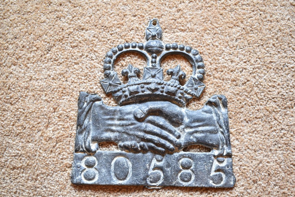 A cast lead fire mark for Hand in Hand Insurance (1696-1905), with policy no.80585, height 22cm.