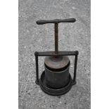 A vintage iron and tin cheese/fruit press, of circular form, height with handle up 49cm. PROVENANCE: