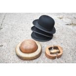 A vintage treen bowler hat maker's mould, in two sections, the underside of the centre section
