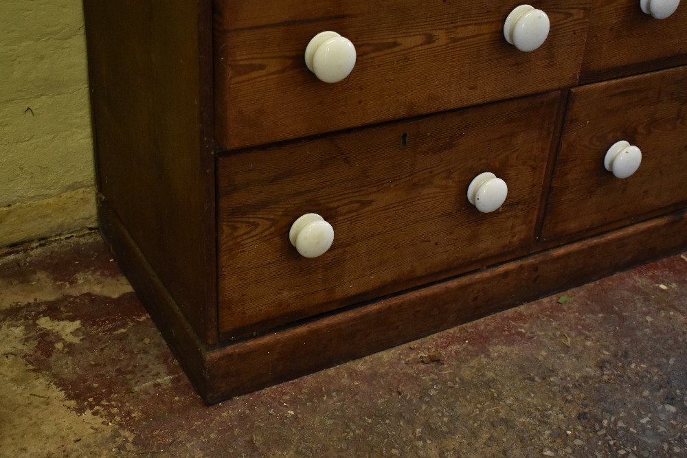 A Victorian pine chest of two rows of four graduated long drawers, with ceramic handles, on plinth - Image 7 of 7