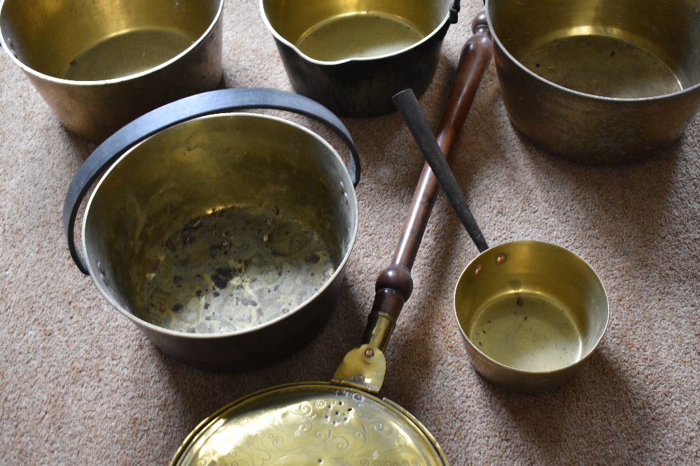 Four brass and cast iron preserving pans, the largest diameter 32.5cm, also a smaller brass saucepan - Image 3 of 4