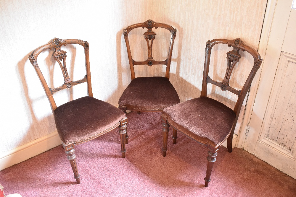 A part set of three Victorian carved walnut dining chairs, and two further walnut dining chairs (5).