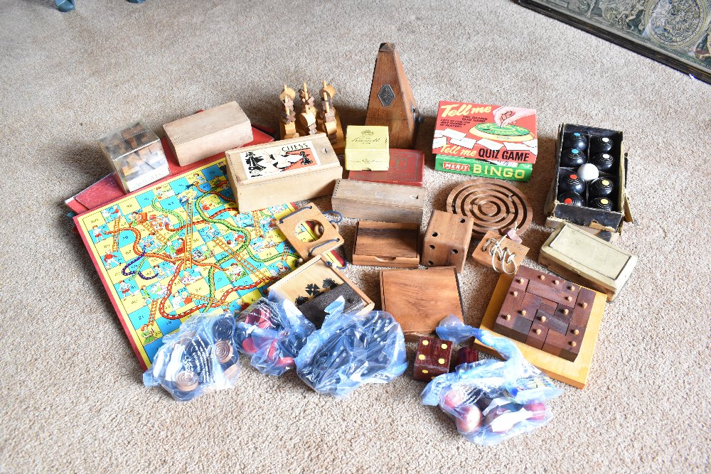 A collection of vintage and modern treen and other toys and games, including Snakes and Ladders