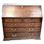 A George III mahogany two-over-three long drawer drop-front bureau, with partially fitted interior.
