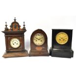 A Victorian ebonised wooden mantel clock, the dial set with gilt Roman numerals,