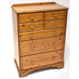 A waxed pine Ducal chest of four short over three long graduated drawers, on bracket feet,