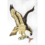 A large vintage cast metal wall plaque/sign depicting an eagle in flight with salmon in talons,