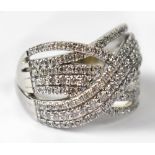 A 9ct white gold dress ring of eight wrythen bands set with diamonds, 122 stones in total, each 0.