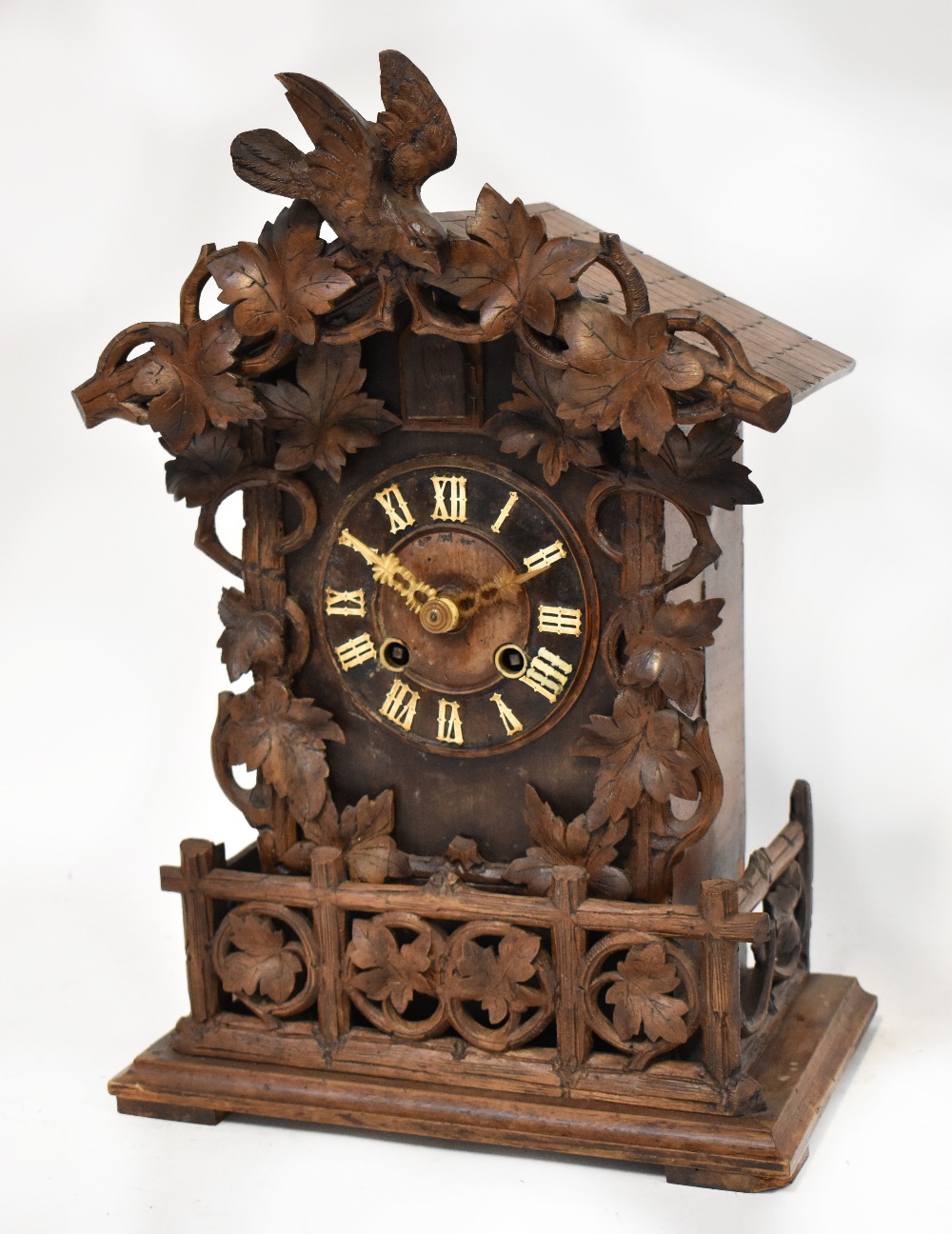 A late 19th century Black Forest bracket cuckoo clock, the dial set with Roman numerals,