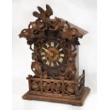 A late 19th century Black Forest bracket cuckoo clock, the dial set with Roman numerals,