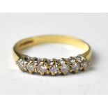 A 9ct gold ring set with seven small diamonds.