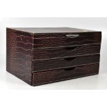 A leather-effect three-drawer jewellery box with mirrored lid,